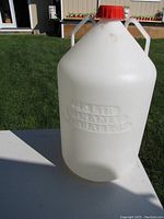 Photo of the 25 liter plastic carboy showing its size, shape, two handles and embossed volume lettering.
