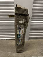 Carrying bag with Big Top branding and product info label on it, standing upright on concrete floor.