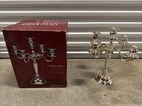Photo of Oneida Chippendale silver plated five-arm candelabra alongside its original box