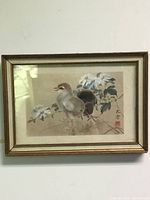 Full view of framed Chinese painting showing two birds next to white flowers, mounted in a gold frame.