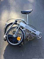 Folded Bickerton Portable collapsible bike showing compact folded size with saddle and logo visible