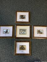 Full view of the five framed pieces arranged on floor showing the set and layout.