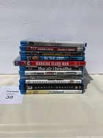 Lot of 12 Blu-Ray movies stacked showing titles and packaging condition