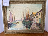 Full view of the oil painting in its ornate frame showing the harbor scene with sailing ships and buildings.