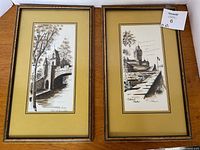 Pair of framed watercolor paintings showing port scenes with architectural details and trees, both signed bottom right, in good condition.