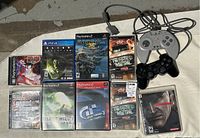Overview showing nine game cases and two controllers on fabric.