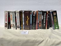 Front view showing multiple vintage DVD box sets lined up horizontally on a cloth surface against a white backdrop.