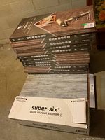 Stack of 13 flooring boxes, vapour barrier box and J roller on top
