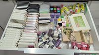 Overhead view of drawer containing ink pads, ink refills, adhesives, stamps and embellishments