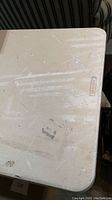 Close-up of the white plastic tabletop surface with visible usage marks and embossed Lifetime logo.