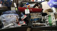 Photo showing the contents inside the Husky tool tote including packages of door handles, assorted hardware, and hand tools.