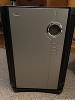 Front view of Bonaire air purifier showing rectangular unit with black and silver casing on carpeted floor.
