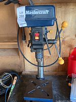 Front view of the Mastercraft drill press showing controls and base.