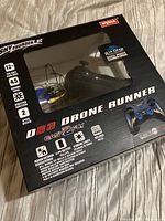Boxed Sky Thunder D63 Drone Runner remote control drone showing front of packaging with drone visible inside and controller image on packaging.
