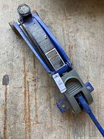 Full view of Michelin blue hydraulic floor jack, showing body, handle, wheels, and lifting arm.