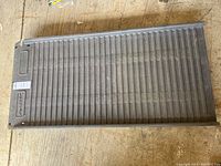 Top view of Petstep pet ramp showing ribbed texture and folded condition on concrete floor