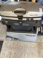 Full view of Thermos Grill 2 Go showing top grill and wheels at bottom