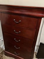 Front view of the 5 drawer solid wood tall boy dresser with metal handles.