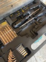 Close-up of wire strip cutter and small screwdriver in case