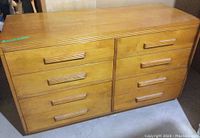 Front view of the vintage pine dresser showing all 8 drawers and ribbed wooden handles.