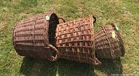 Three woven baskets stacked, showing size differences and wear.