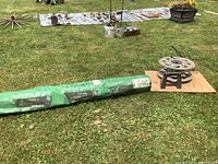 Overall view of landscape fabric roll and mounted hose reel on grass.