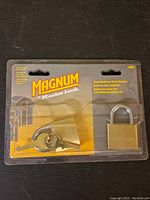 Front view of Magnum padlock with keys in original packaging showing brand and model details.