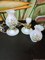 Pair of vintage white milk glass lamps, hobnail bases and floral shades, one with bulb installed, electrical cords included
