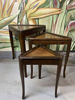 Group photo showing all three wooden triangular nesting tables stacked together in descending size order.