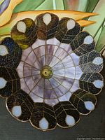 Top down view showing the floral patterned stained glass with purple, black, green, and white colors.