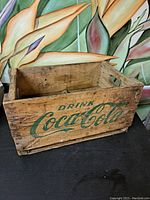 Front and side view showing Coca-Cola logo and wooden crate construction