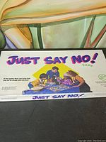 Photo of game box front showing logo, title, and children playing game.