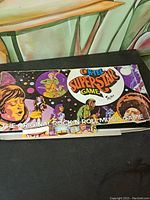 Top and side views of vintage K-Tel Superstar Game box with rock 'n roll music themed cover art and signs of wear.