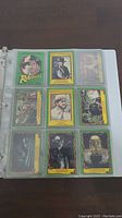 Photo of first binder page with 9 Indiana Jones trading cards, including character portraits and artifact images.