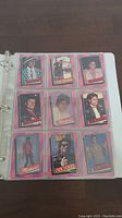 First binder page with nine Michael Jackson trading cards in protective sleeves featuring a variety of images of Michael Jackson from 1984.
