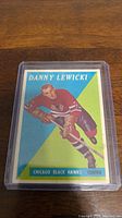 Photo of the Danny Lewicki hockey card from the 1958-59 Topps set in protective case showing the front of the card with player image and details.