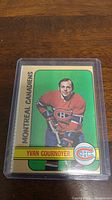 1972-73 Topps hockey card featuring Yvan Cournoyer in Montreal Canadiens uniform inside protective plastic sleeve.