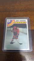 Photo showing a single Larry Robinson hockey card from the 1978-1979 Topps set in protective plastic sleeve.