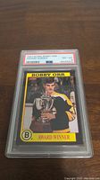Photo of a 1991 Score Bobby Orr Award Winner hockey card in PSA graded slab showing the front side of the card with Bobby Orr holding a trophy.