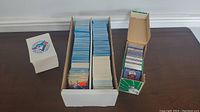 Wide shot of three boxes containing over 1500 Toronto Blue Jays baseball cards. The boxes show the volume and storage method for the collection.