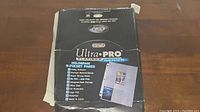 Partial box of Ultra Pro Platinum Series 9-pocket pages for storing and displaying collectible cards.