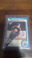 Close-up photo of the Wayne Gretzky Edmonton Oilers hockey card in a protective plastic case with facsimile autograph.