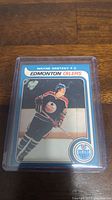 Front side of Wayne Gretzky Edmonton Oilers rookie reprint hockey card in protective plastic.