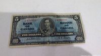 Front side of the 1937 Canadian five dollar bill showing King George VI portrait and serial number 4769587.