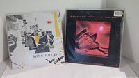 Both vinyl albums seen side by side showing front covers of the two Midnight Oil albums.