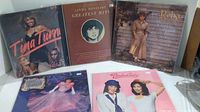 Wide shot showing 5 vinyl albums from female artists, with visible titles including Tina Turn, Linda Ronstadt Greatest Hits, Reba McEntire, and two others with less clear text.