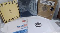 Five vinyl albums with visible covers and labels for techno and remix music