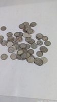 Overview of all 64 silver quarters spread on white background