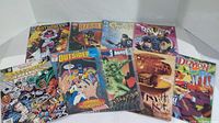 Nine DC Comics comic books arranged on a white background showing colorful cover art with varying characters and titles.