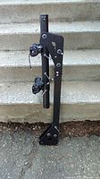 Full side view of the DK2 bike rack showing vertical post and foldable arm with adjustable straps.